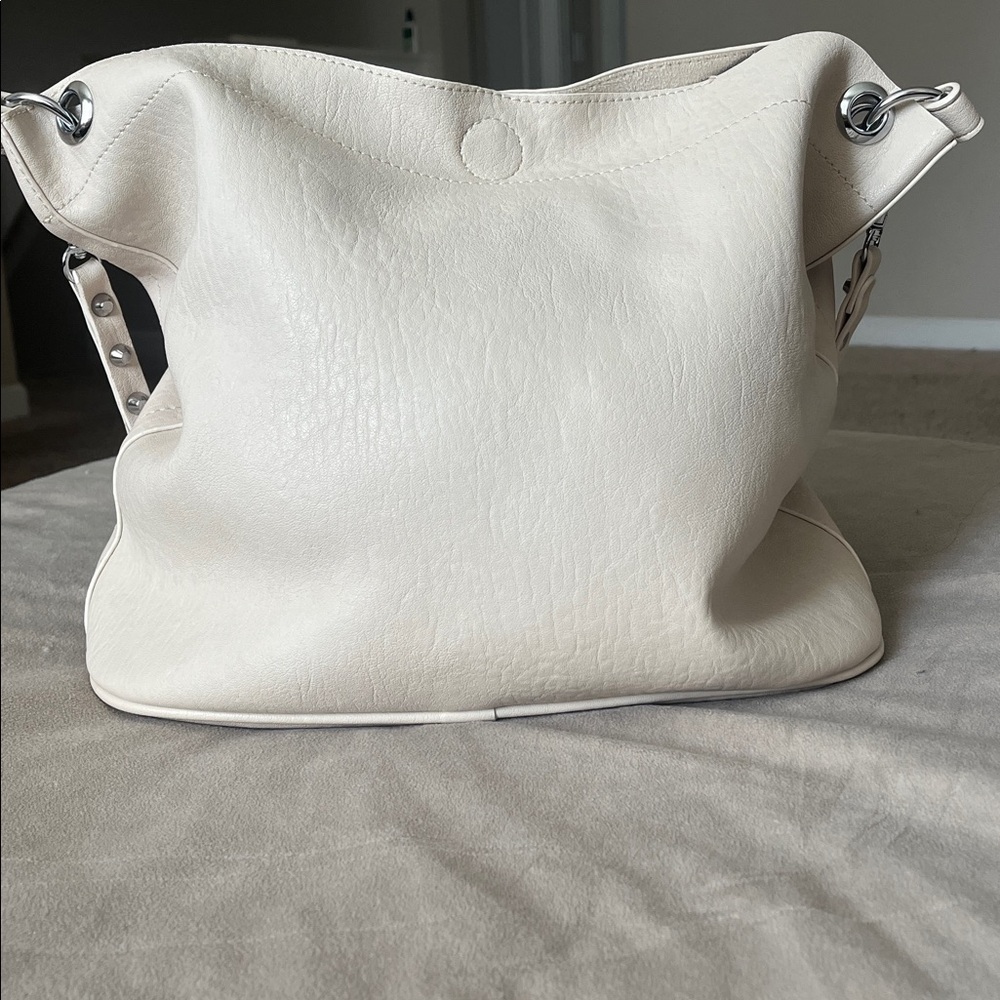 Madison West Purse in a purse
Cream purse w/ silver details. - Picture 2 of 6